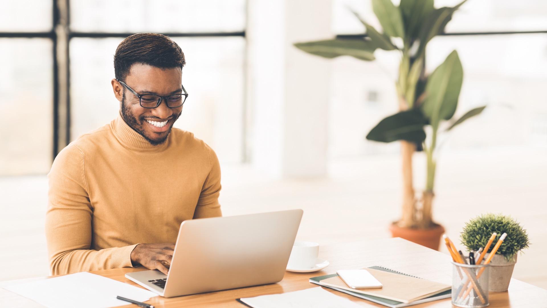 Man at desk on laptop computer